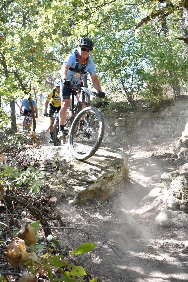 Mountain bikers racing down a rocky Oklahoma singletrack trail